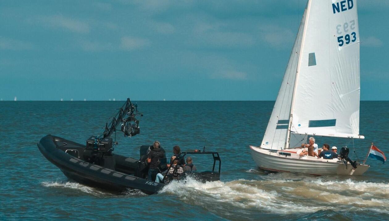 Poseidon with crane filming sailboat
